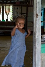 Fijian child at the doorwary to the school in the village